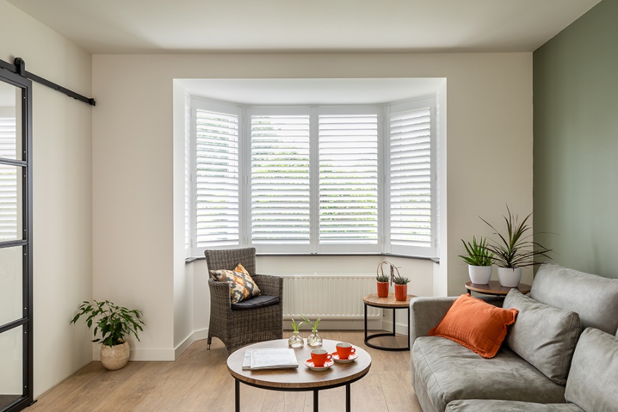 Baie vitrée dans un salon avec shutters