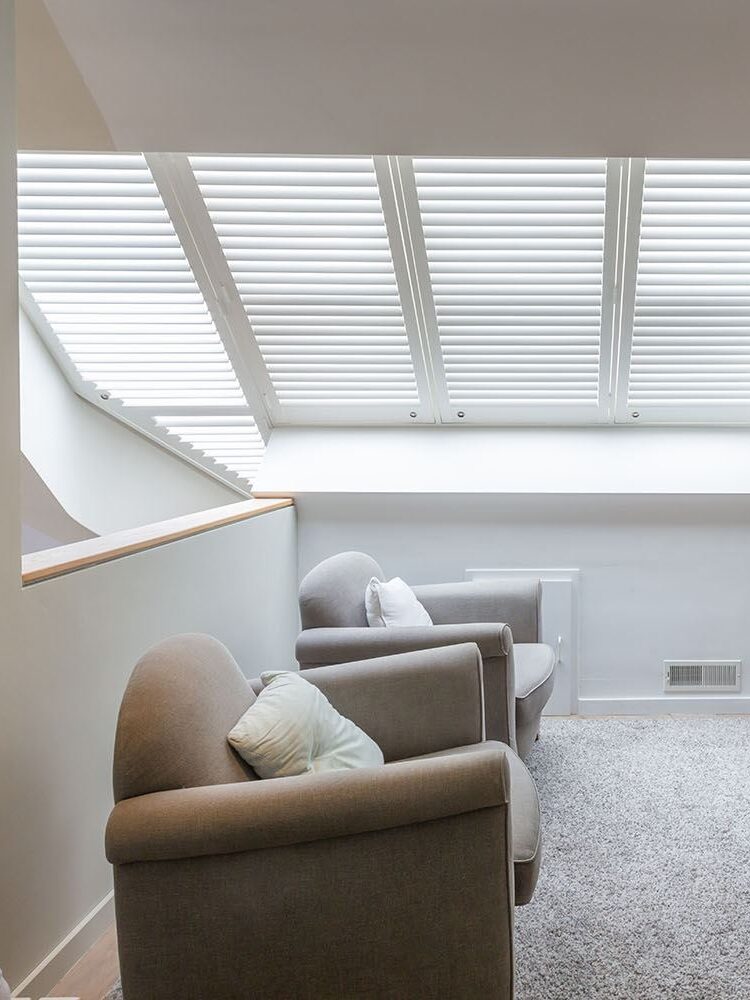 Shutters blancs dans la lucarne du palier